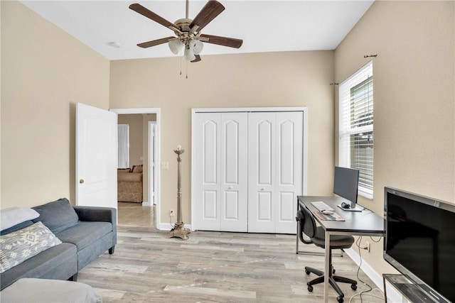 office with ceiling fan and light hardwood / wood-style flooring