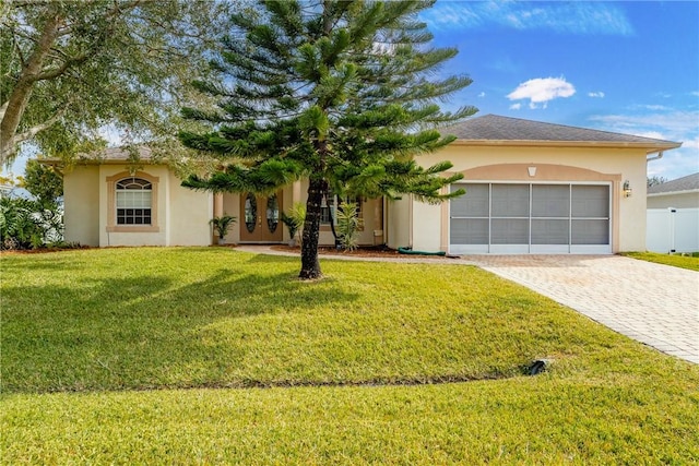 view of front of property with a front lawn and a garage