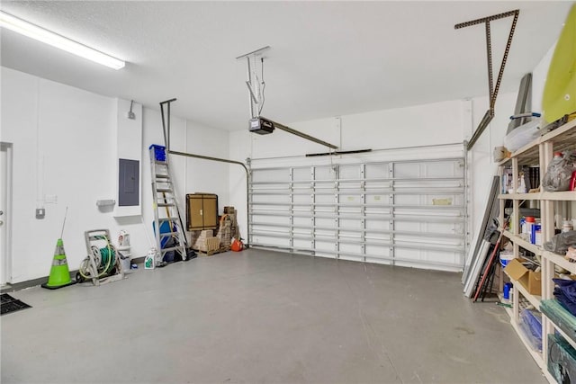 garage with a garage door opener and electric panel