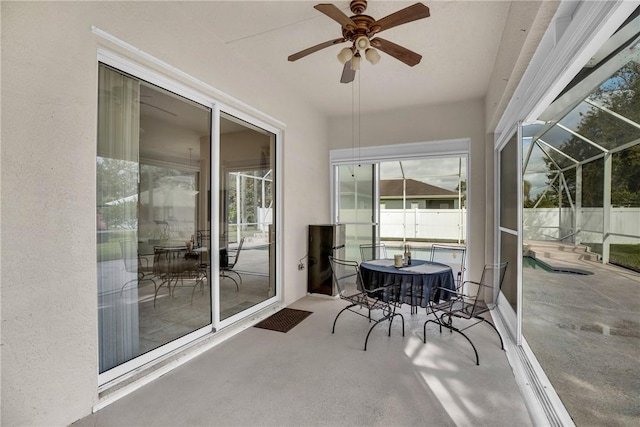 sunroom featuring ceiling fan