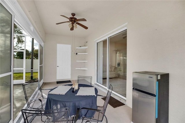 sunroom featuring ceiling fan