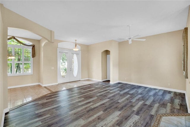 entrance foyer with ceiling fan, french doors, dark hardwood / wood-style flooring, and a wealth of natural light