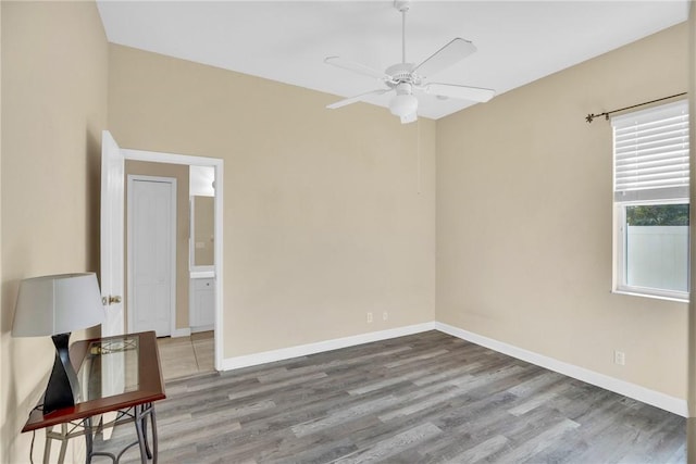 empty room with ceiling fan and light wood-type flooring