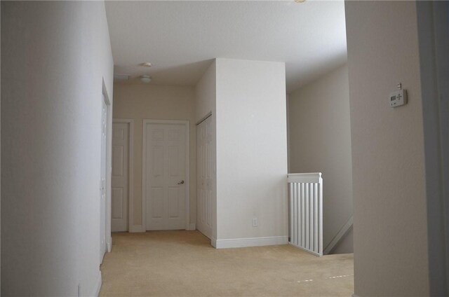 1073 Cheval Dr, Vero Beach, FL 32960 - corridor featuring an upstairs landing, carpet, and baseboards