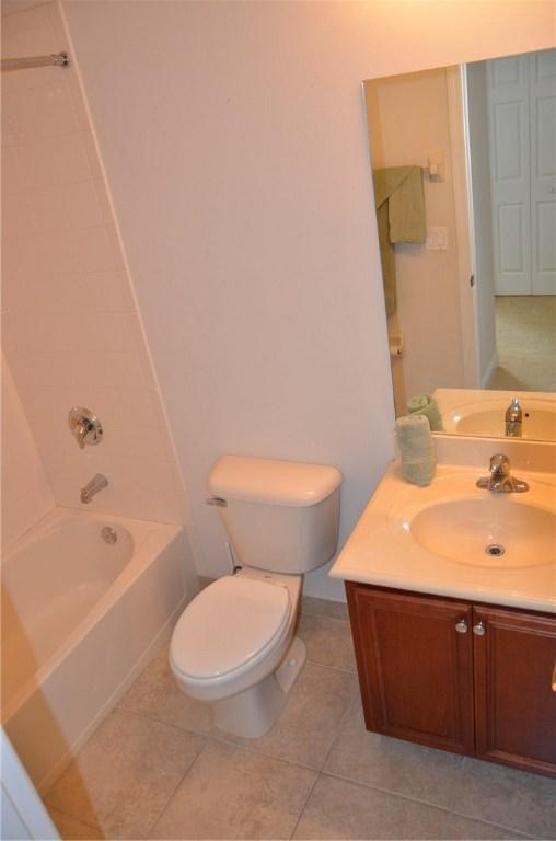 1073 Cheval Dr, Vero Beach, FL 32960 - bathroom with vanity, toilet, shower / bathtub combination, and tile patterned flooring