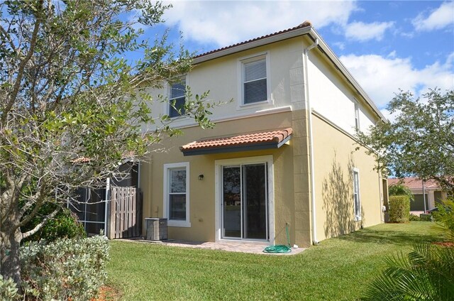 1073 Cheval Dr, Vero Beach, FL 32960 - rear view of property with a yard, stucco siding, and central AC