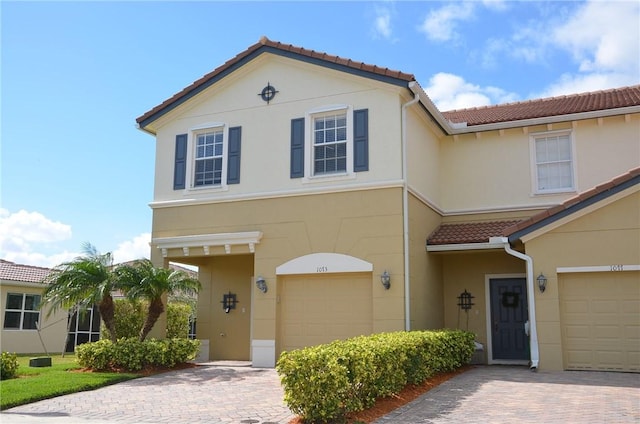 1073 Cheval Dr, Vero Beach, FL 32960 - multi unit property featuring a tiled roof, a garage, and decorative driveway