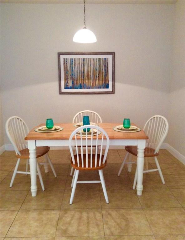 1073 Cheval Dr, Vero Beach, FL 32960 - dining space with baseboards and light tile patterned floors