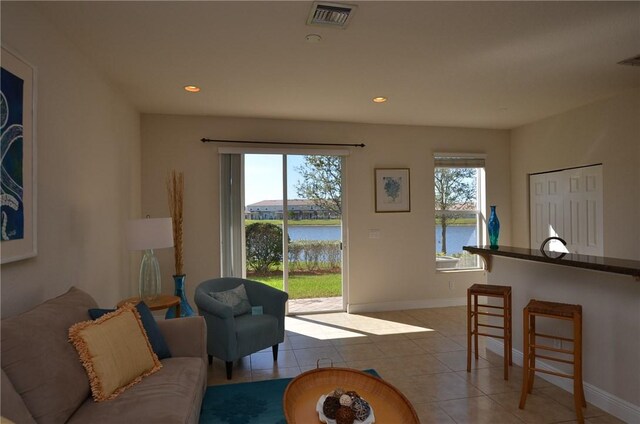 1073 Cheval Dr, Vero Beach, FL 32960 - living area with a water view, light tile patterned floors, baseboards, and recessed lighting