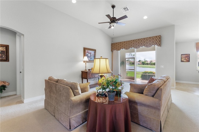 living room with ceiling fan, light colored carpet, and lofted ceiling