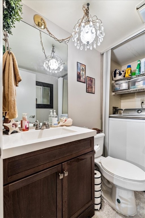 bathroom featuring toilet, vanity, and a notable chandelier