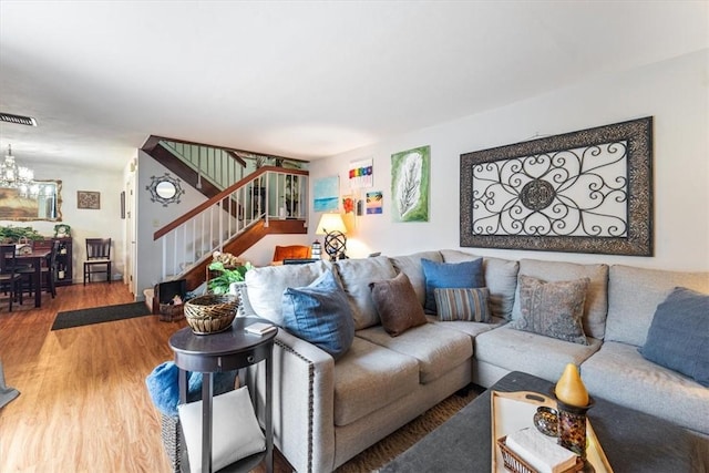 1170 6th Ave Unit 9D, Vero Beach, FL 32960 - living room featuring stairs, a chandelier, and wood finished floors
