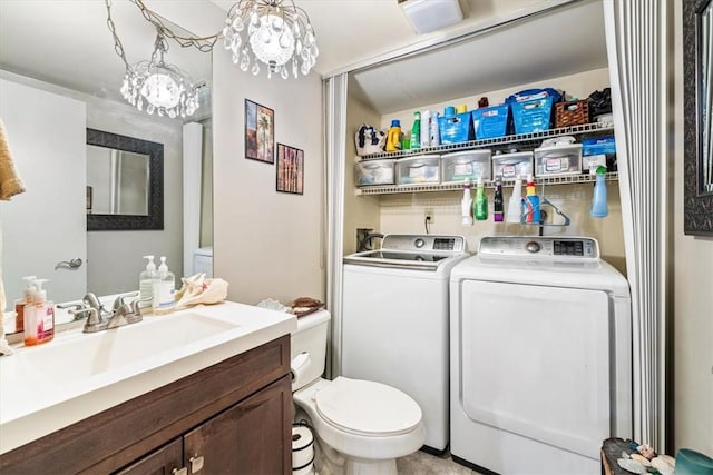1170 6th Ave Unit 9D, Vero Beach, FL 32960 - bathroom featuring toilet, washer and clothes dryer, vanity, and a chandelier
