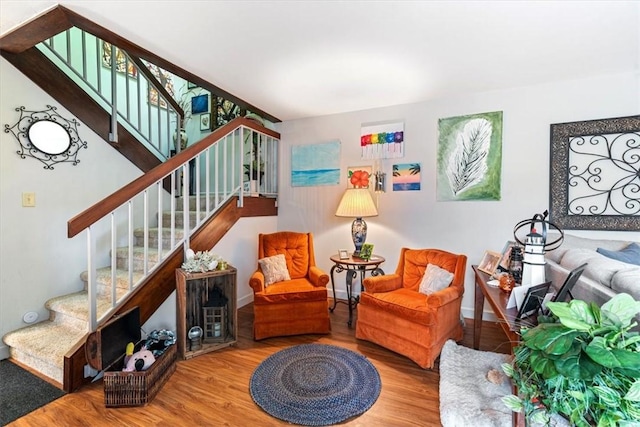 1170 6th Ave Unit 9D, Vero Beach, FL 32960 - sitting room featuring wood finished floors, stairway, and baseboards