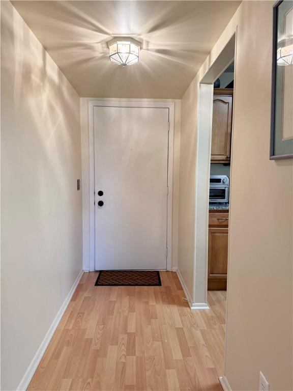 doorway to outside with light wood-type flooring