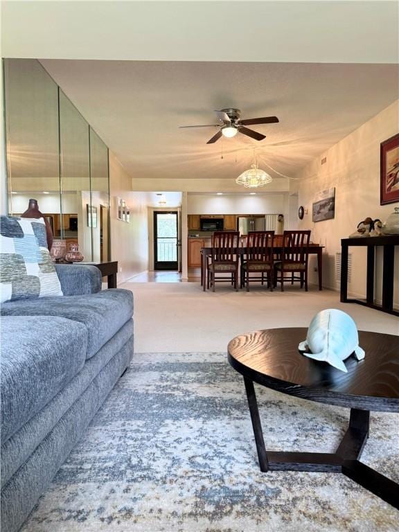 living room with light carpet and ceiling fan