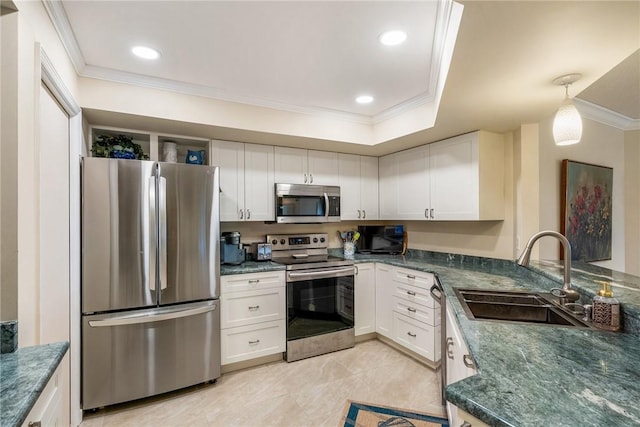 kitchen featuring white cabinetry, appliances with stainless steel finishes, crown molding, and sink