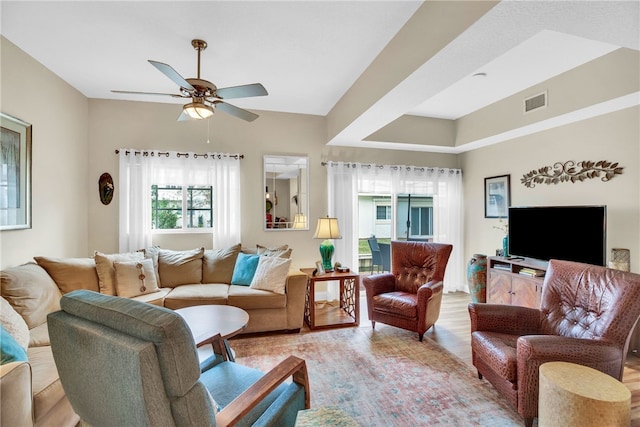 living room featuring ceiling fan and light wood-type flooring