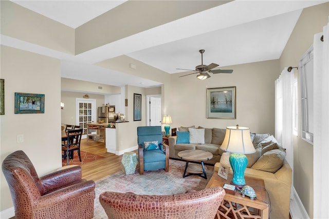 living room featuring ceiling fan and light hardwood / wood-style floors