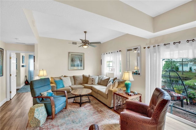 living room featuring hardwood / wood-style floors and ceiling fan