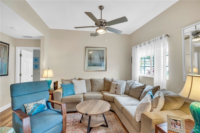 living room with hardwood / wood-style floors, vaulted ceiling, and ceiling fan