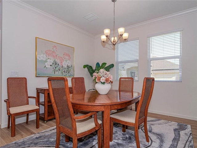 dining area with a notable chandelier, baseboards, light wood finished floors, and ornamental molding