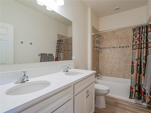 full bath with shower / bath combination with curtain, wood finished floors, double vanity, and a sink