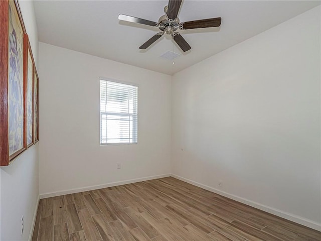 unfurnished room featuring baseboards, light wood-style flooring, and a ceiling fan