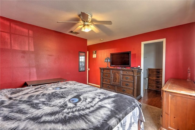 bedroom with dark wood-type flooring, visible vents, and ceiling fan