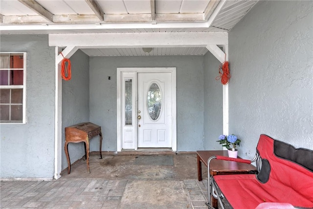 view of exterior entry with stucco siding