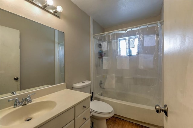 full bath with vanity, wood finished floors, shower / bath combo with shower curtain, and toilet