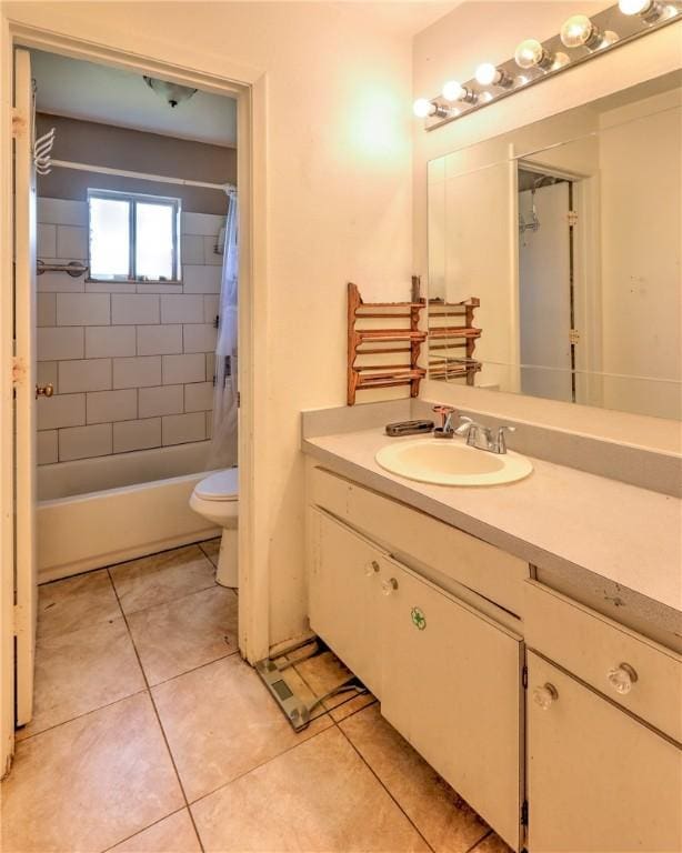 bathroom featuring tile patterned flooring, vanity, toilet, and shower / bath combo