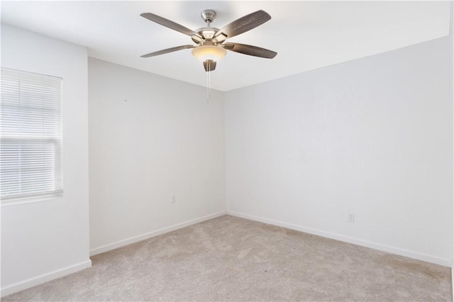 empty room featuring ceiling fan and light carpet