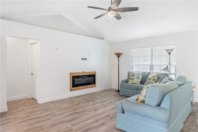 living room featuring vaulted ceiling, light hardwood / wood-style floors, and ceiling fan