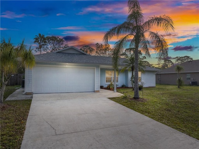 view of front of house featuring a garage and a yard