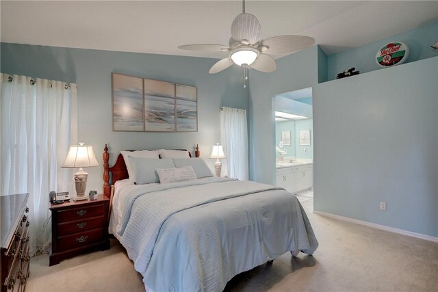 907 Starflower Ave, Sebastian, FL 32958 - bedroom featuring baseboards, ensuite bathroom, light carpet, and a ceiling fan