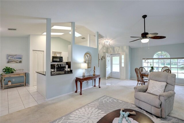 907 Starflower Ave, Sebastian, FL 32958 - living area featuring a ceiling fan, visible vents, vaulted ceiling, light carpet, and a wealth of natural light