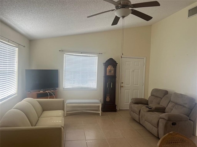 living room featuring ceiling fan, light tile patterned floors, and a healthy amount of sunlight