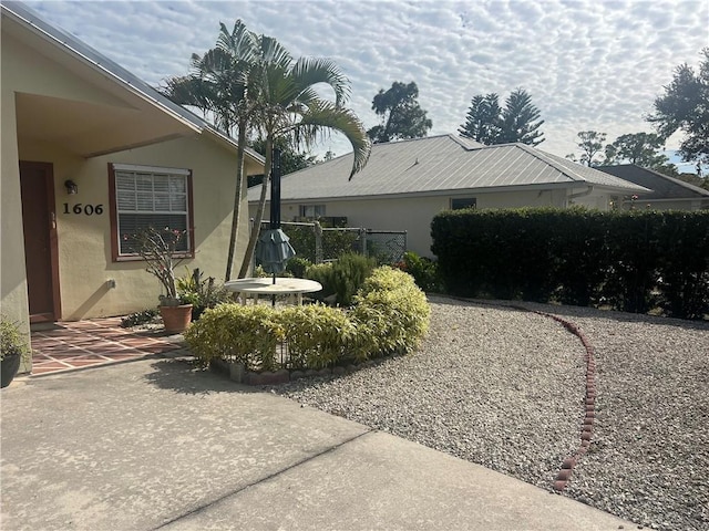 view of property exterior with a patio