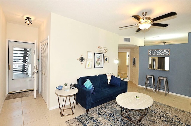 1910 Westminster Cir Unit 14-1, Vero Beach, FL 32966 - living area featuring light tile patterned flooring, baseboards, and ceiling fan