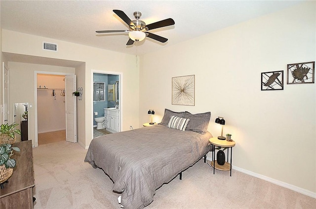 1910 Westminster Cir Unit 14-1, Vero Beach, FL 32966 - carpeted bedroom with baseboards, ensuite bathroom, a spacious closet, and ceiling fan