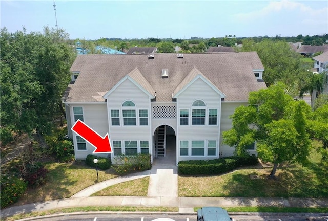 1910 Westminster Cir Unit 14-1, Vero Beach, FL 32966 - townhome / multi-family property featuring roof with shingles and a front lawn