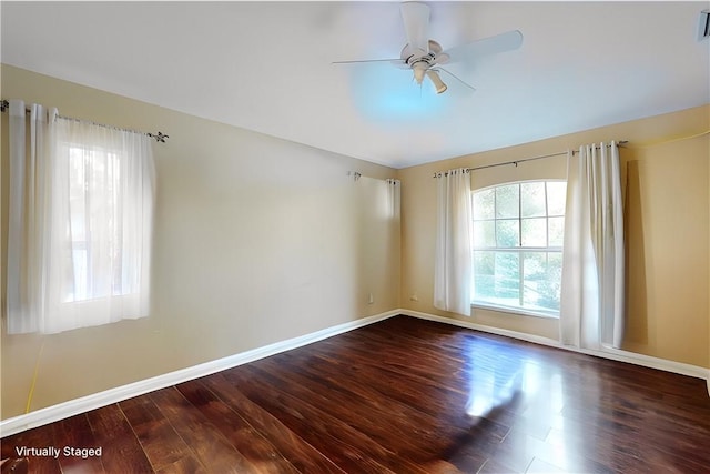 unfurnished room with a ceiling fan, baseboards, and wood finished floors