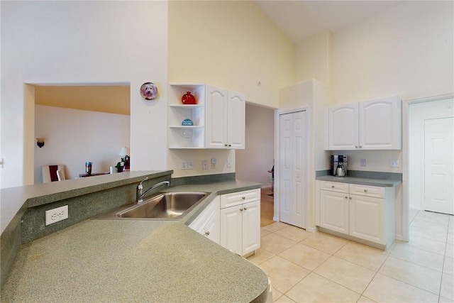 kitchen featuring white cabinetry, a sink, and light tile patterned floors