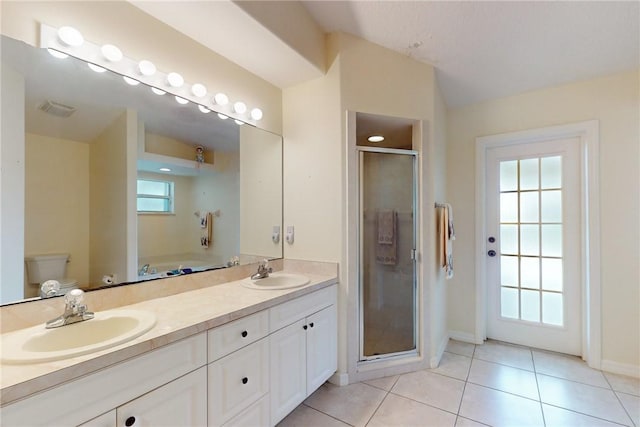 bathroom featuring vaulted ceiling, a sink, toilet, and tile patterned floors