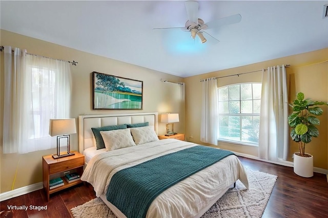 bedroom featuring dark wood-type flooring, visible vents, baseboards, and a ceiling fan