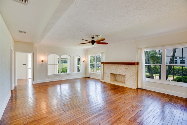 unfurnished living room featuring a healthy amount of sunlight and wood-type flooring