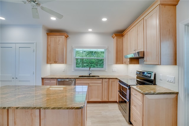 kitchen featuring light stone countertops, light brown cabinets, stainless steel appliances, and sink