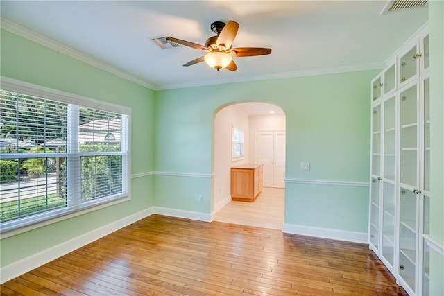 spare room featuring ceiling fan, light hardwood / wood-style flooring, and ornamental molding