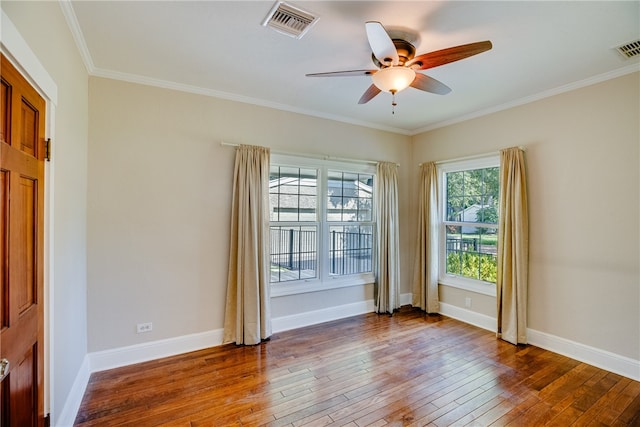 empty room featuring wood-type flooring, ceiling fan, and crown molding